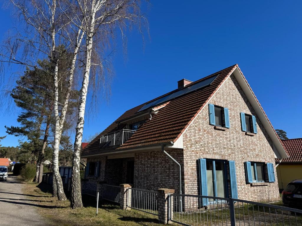 a brown brick house with a brown roof at Haus Ostseeidyll, App 01 in Neuhaus