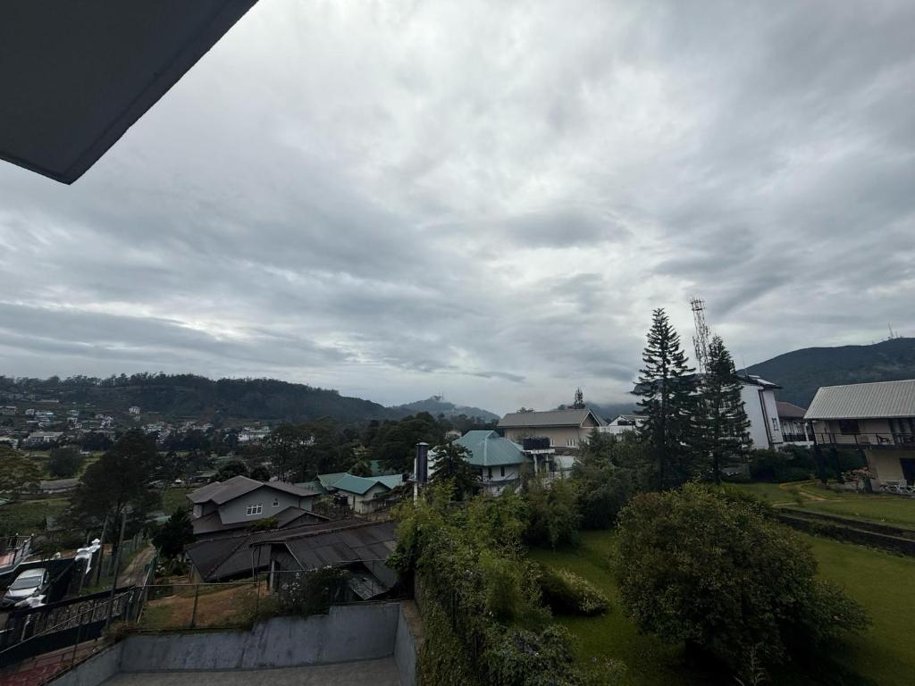 a view of a city with houses and trees at Nomentano Blue -Luxury Apartments- in Nuwara Eliya