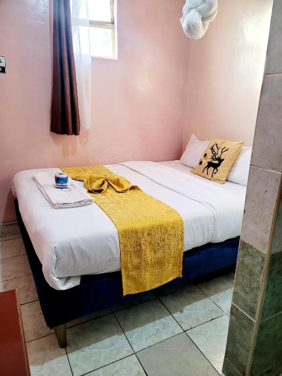 Postel nebo postele na pokoji v ubytování Sislink Hotel Nairobi