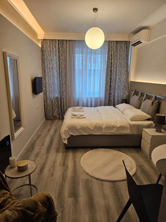 a bedroom with a bed and a living room at TRISAP Luxury Suites T Suite in Thessaloniki