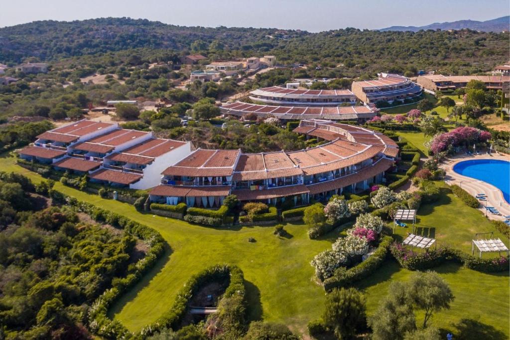 an aerial view of a resort building with a pool at Capo Ceraso Family Resort in Costa Corallina