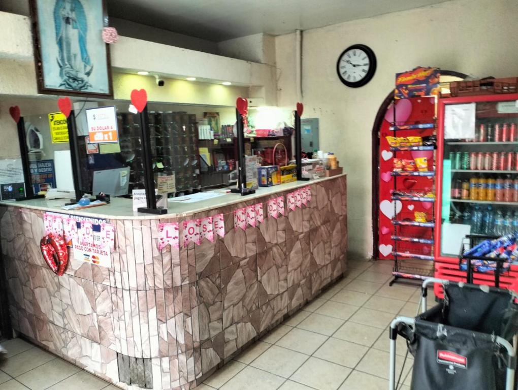 a store with a counter with a clock on the wall at hotel economico in Tijuana