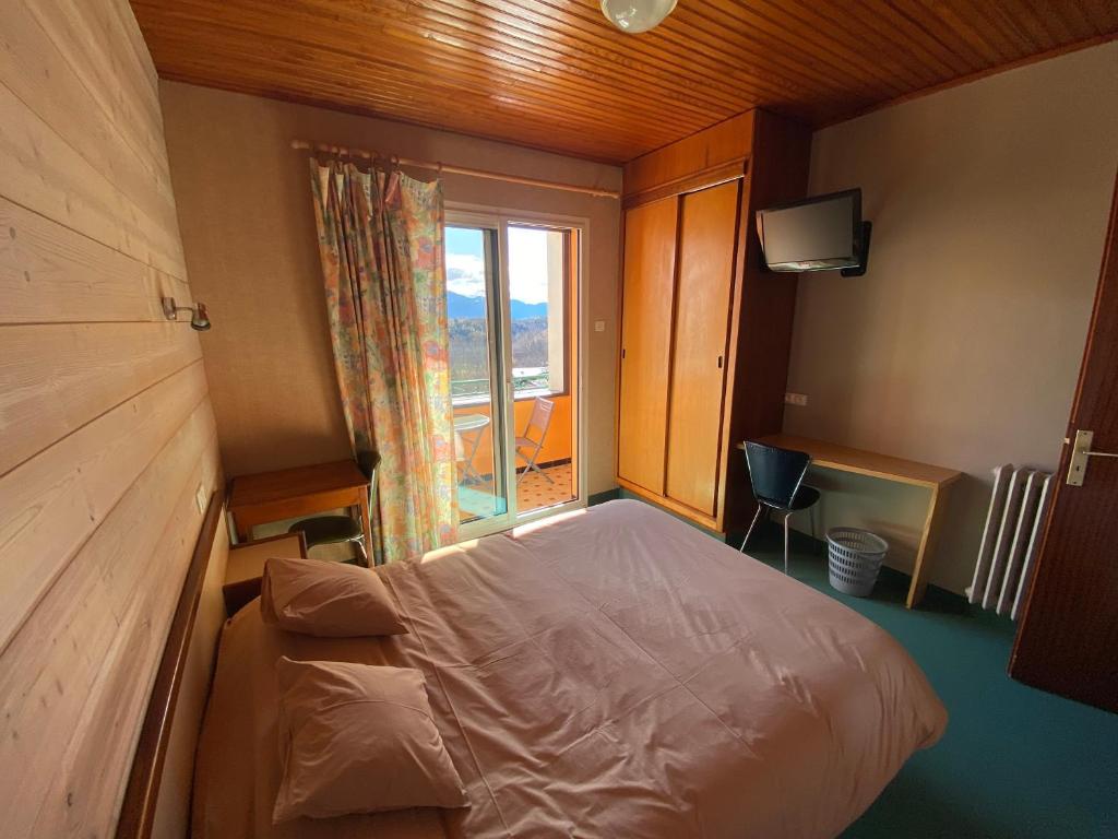 Postel nebo postele na pokoji v ubytování Relais du Belloch