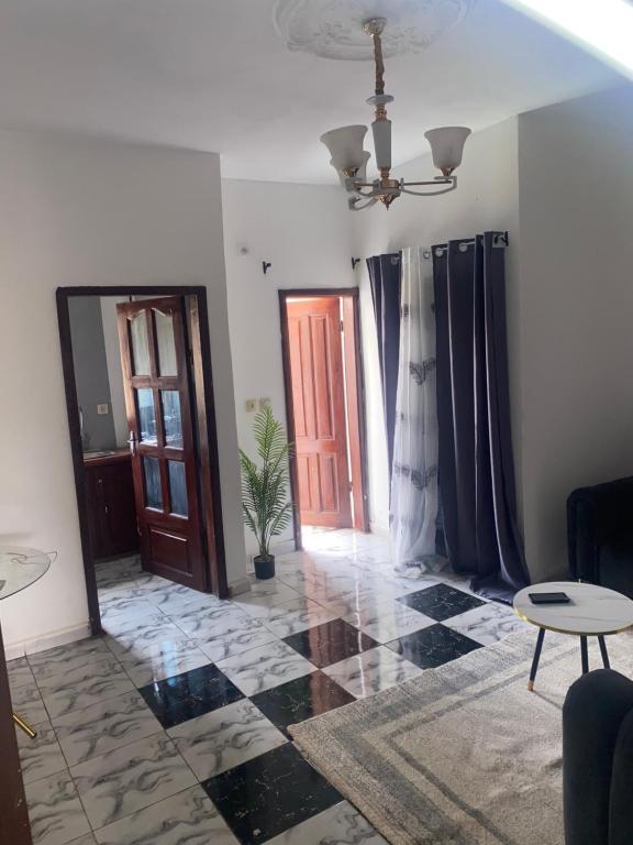 a living room with a door and a floor at FLORILÈGEHome in Yaoundé