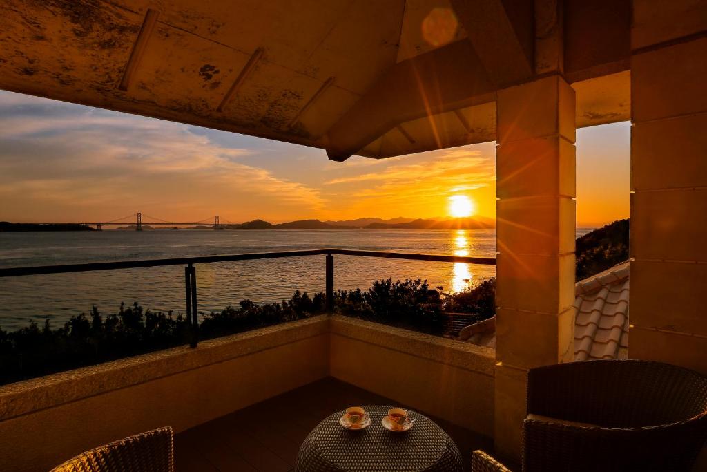 a view of the sunset from the balcony of a hotel at Hotel Anaga in Minamiawaji