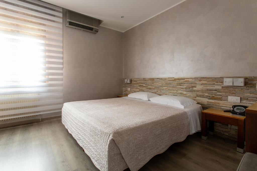 Postel nebo postele na pokoji v ubytování Hotel San Giorgio
