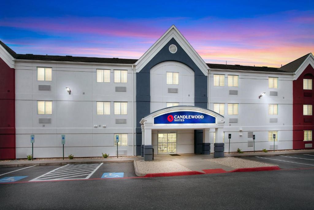 a large white building with a sign on it at Candlewood Suites Harrisonburg by IHG in Harrisonburg