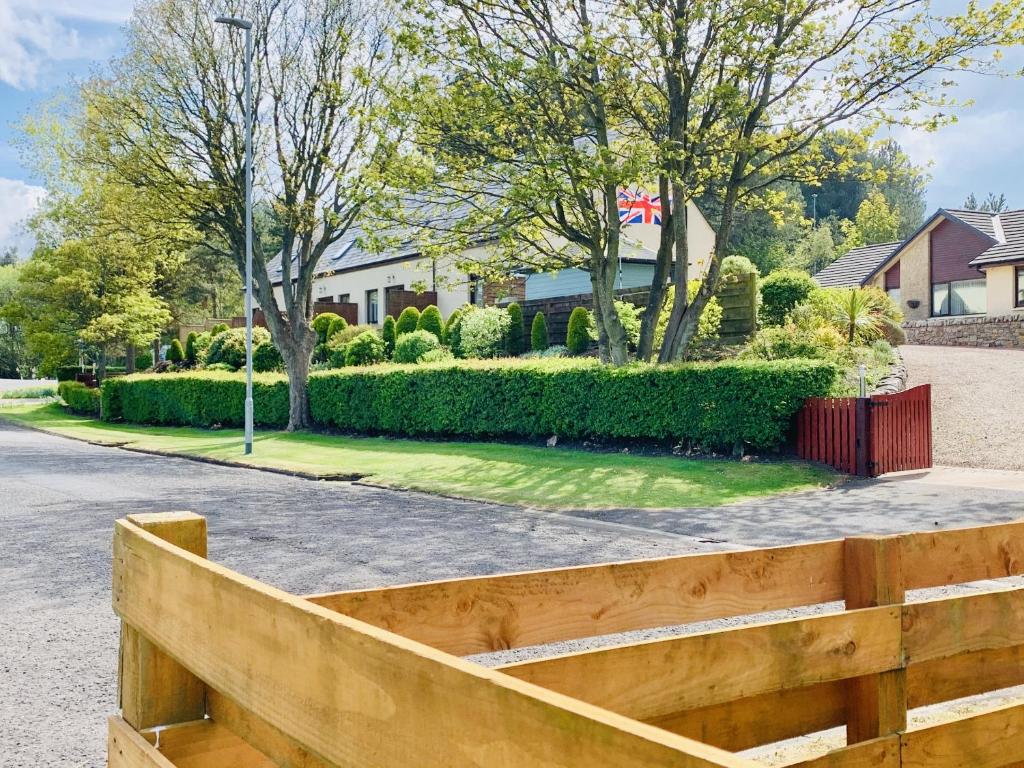 a wooden fence in front of a house at Composers at Woodlands in East Ord