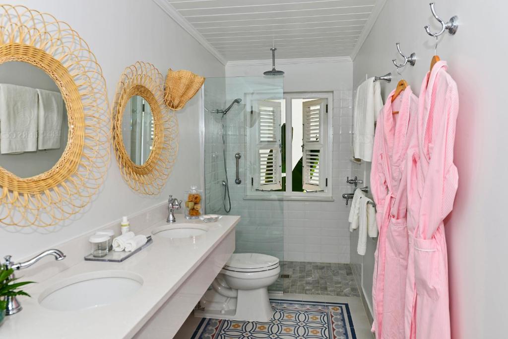 a bathroom with a sink and a toilet and a mirror at Cobblers Cove - Barbados in Saint Peter