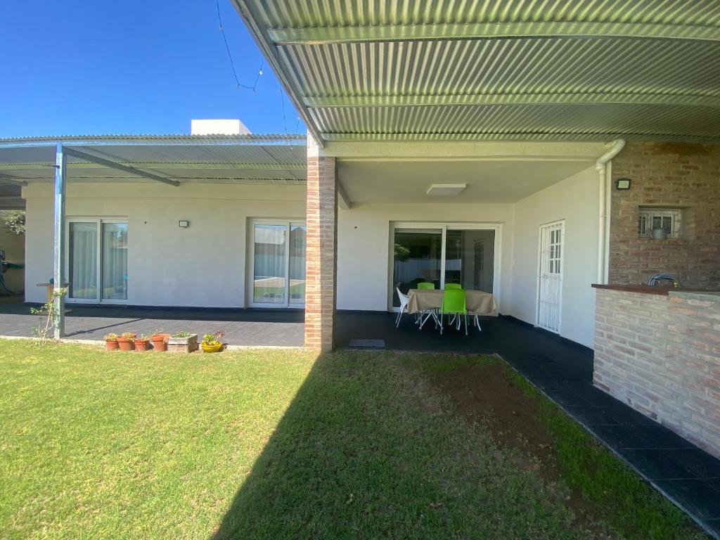 a house with a patio with a grass yard at Soleado Pampa in Santa Rosa