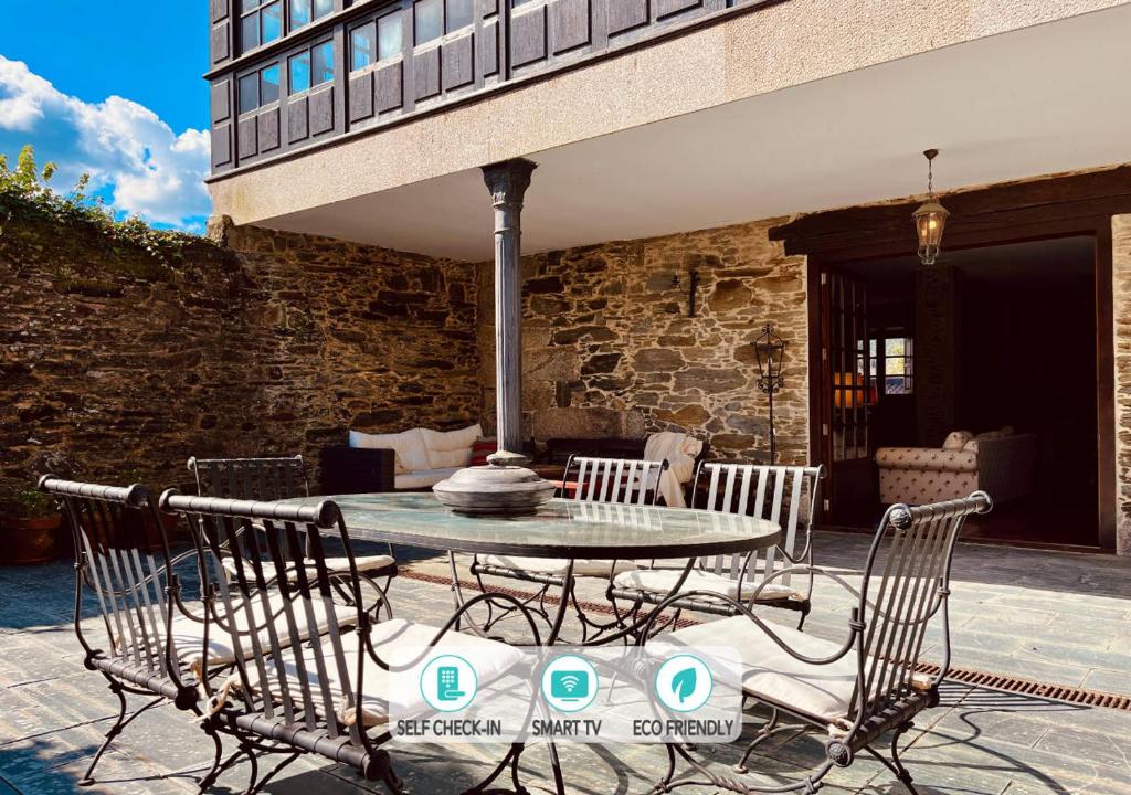 a patio with a table and chairs on a patio at Prioral Countryside Villa in Miño