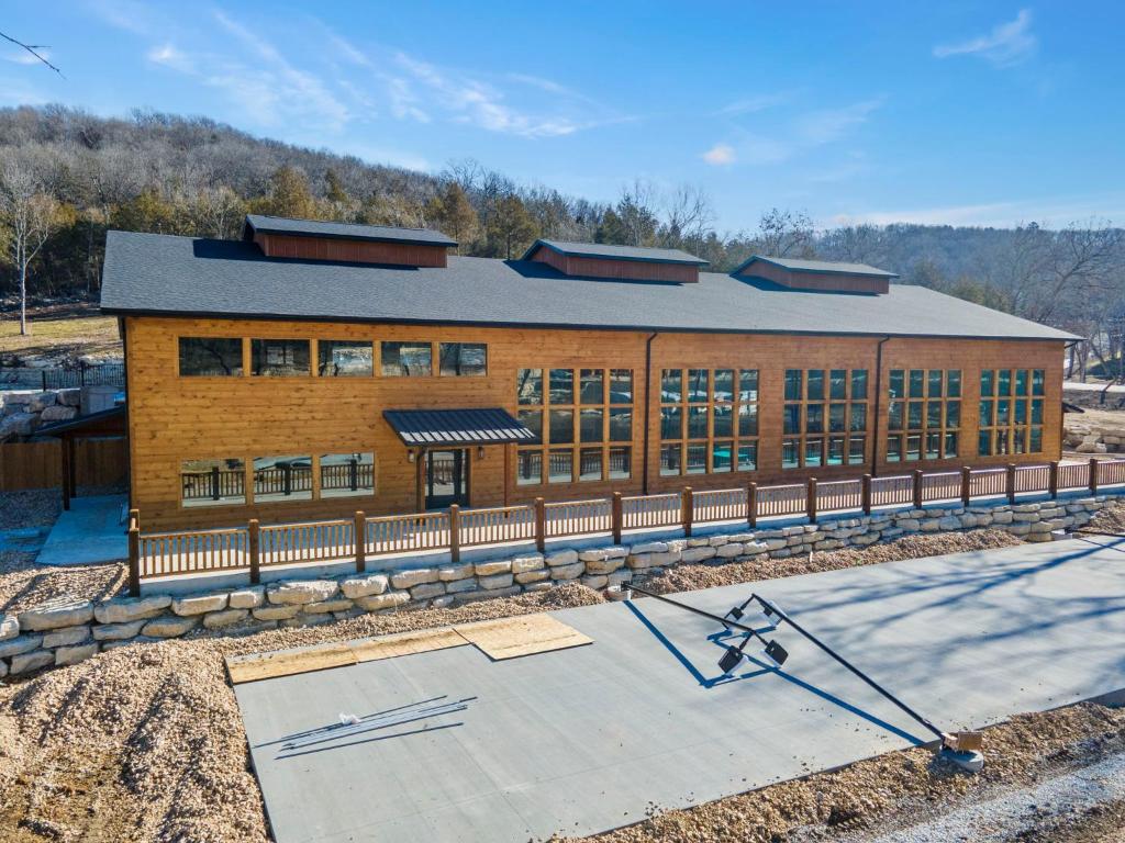 a large brick building with a lot of windows at All New Cabin w Free Attraction Tickets-Pvt Hot Tub-Community Indoor Pool in Hollister