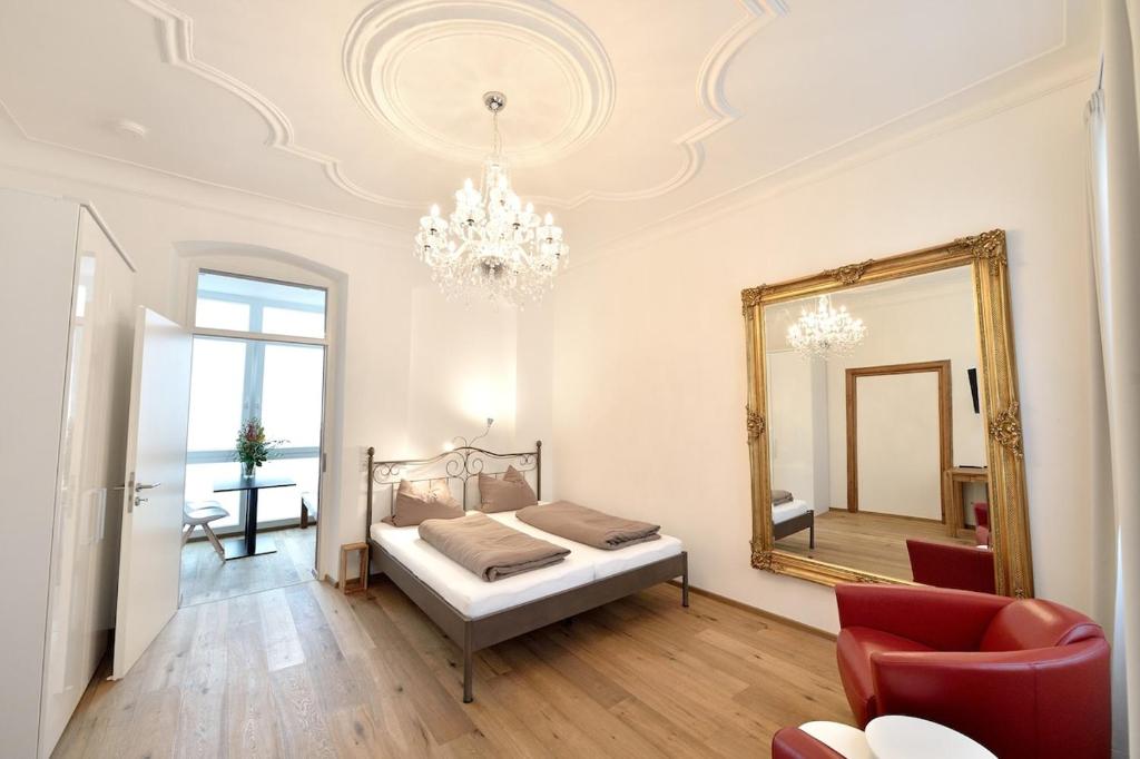 a bedroom with a bed and a mirror at Altstadtapartment Bel Etage in Heidelberg