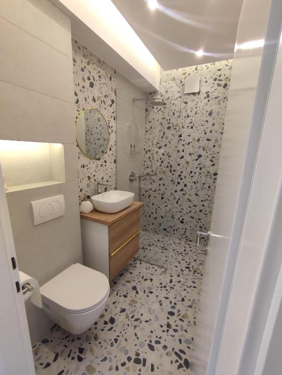 a bathroom with a toilet and a sink and a shower at Mare Blue in Pirovac
