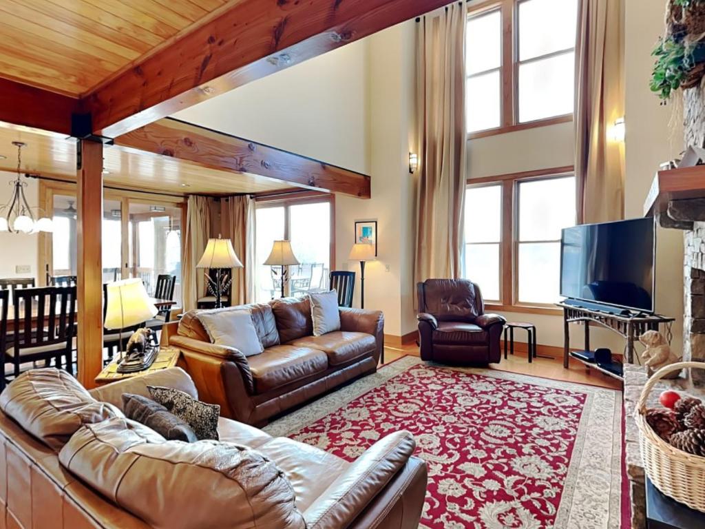 a living room with a couch and a television at Hawk Mountain in McHenry