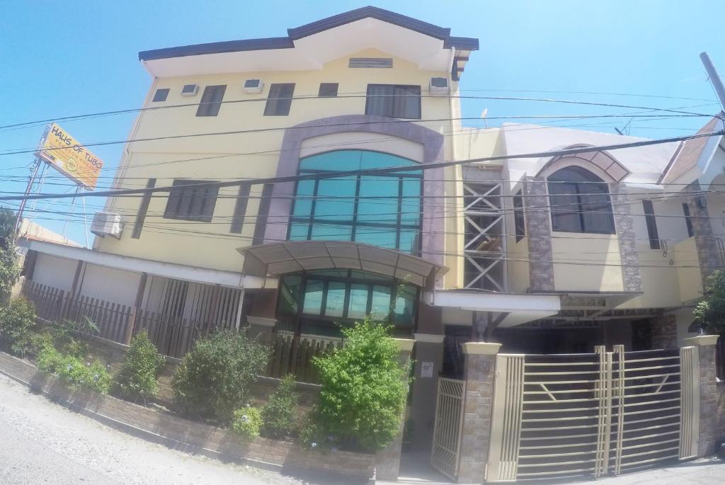 a large house with a fence in front of it at Haus Of Tubo Davao in Davao City