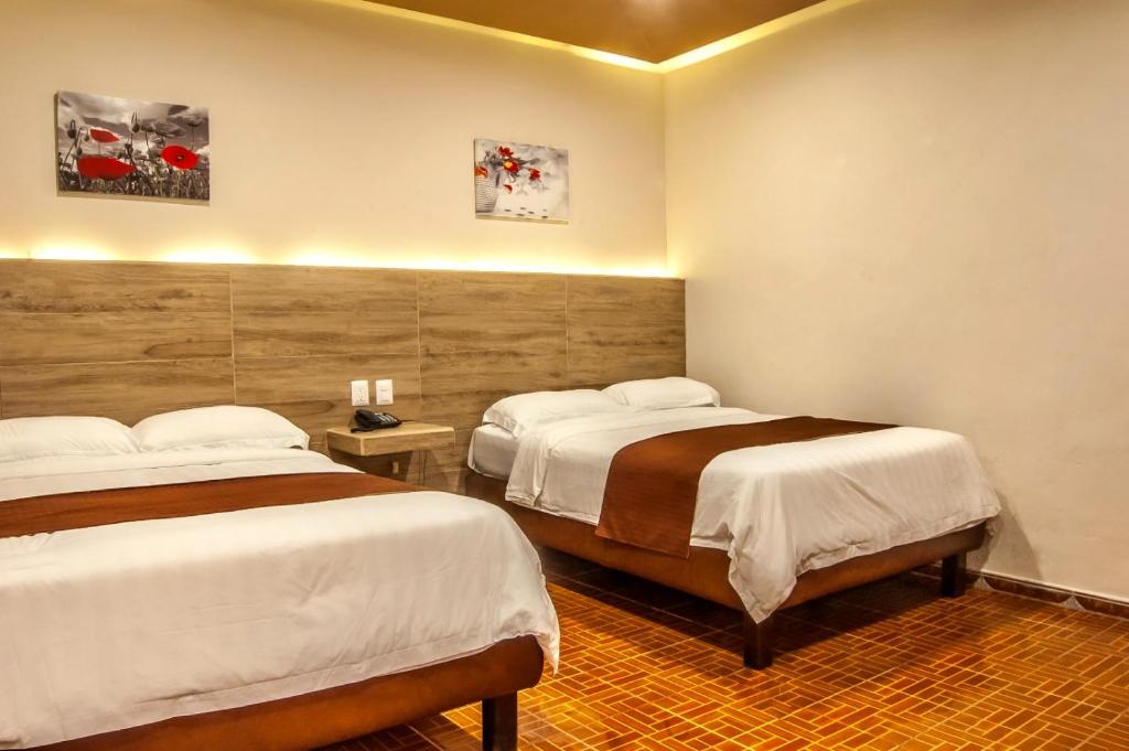 Postel nebo postele na pokoji v ubytování Hotel Luna Caribe