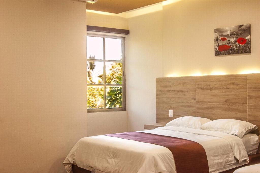 Postel nebo postele na pokoji v ubytování Hotel Luna Caribe