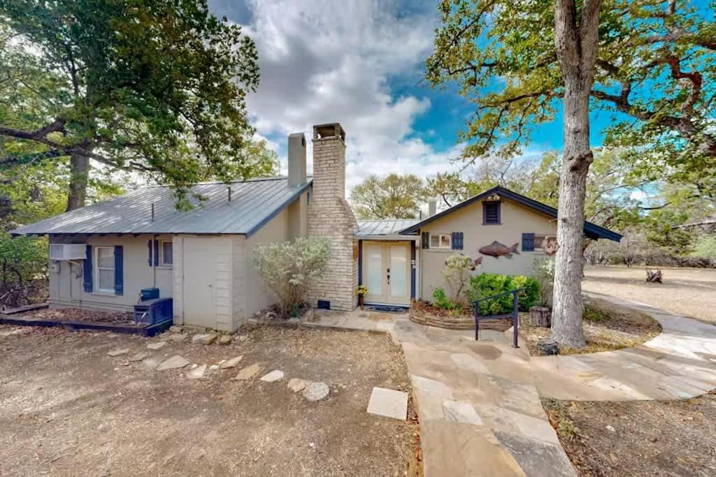 a white house with a chimney and trees at Cozy 2BR Cabin - King Bed Bunks Fire Pit & BBQ in Ingram