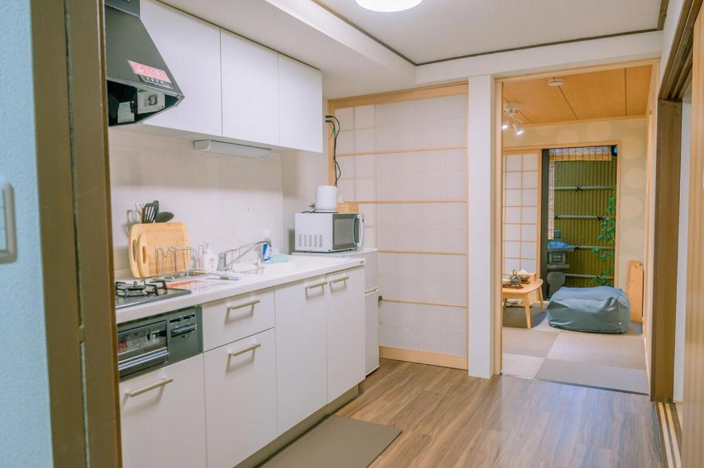 a kitchen with a sink and a stove top oven at Traditional Japanese architecture heiansya in Kyoto