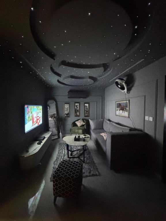 a living room with a couch and a table at Relax Under the Stars 1BHK in Lahore