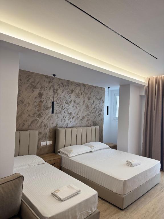 Postel nebo postele na pokoji v ubytování Moonlight Hotel