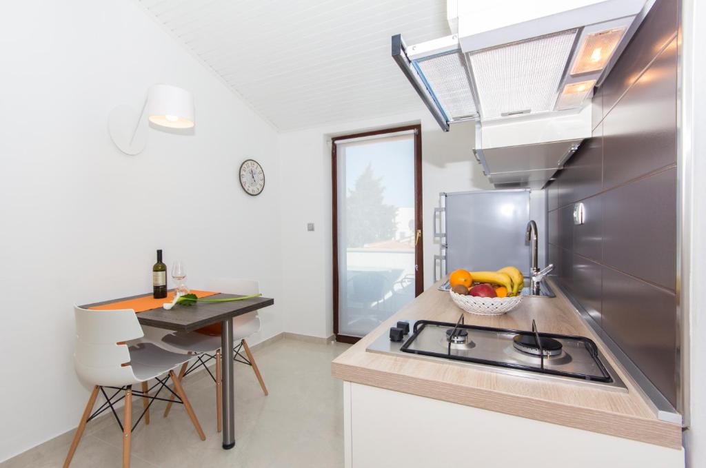 a kitchen with a sink and a counter top at Alison Apartments in Premantura