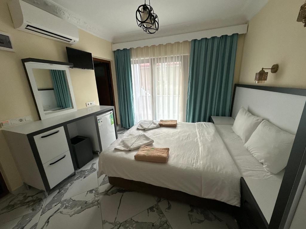 Postel nebo postele na pokoji v ubytování Palm Konak Hotel