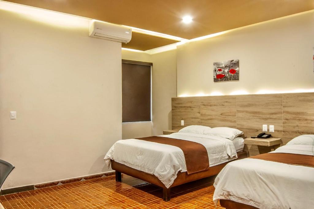 Postel nebo postele na pokoji v ubytování Hotel Luna Caribe