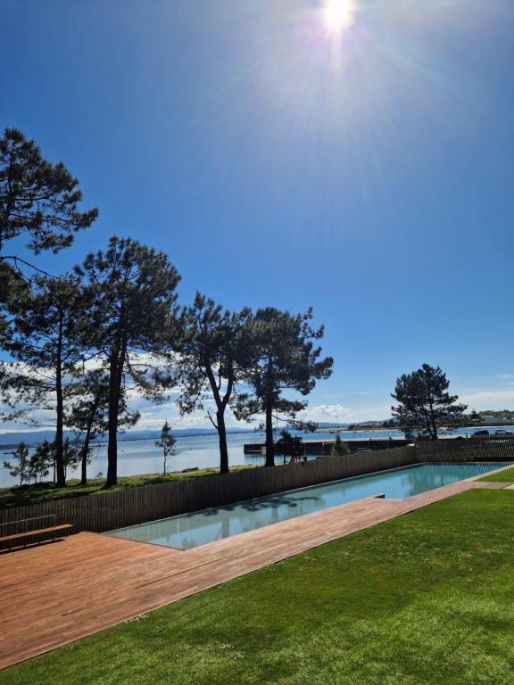 a swimming pool with a view of the ocean at Desconectaengalicia Rincón de Cabodeiro in Isla de Arosa