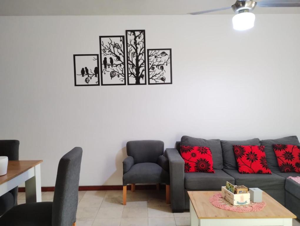 a living room with a couch and a table at Depto cómodo por Av Libertador in San Juan