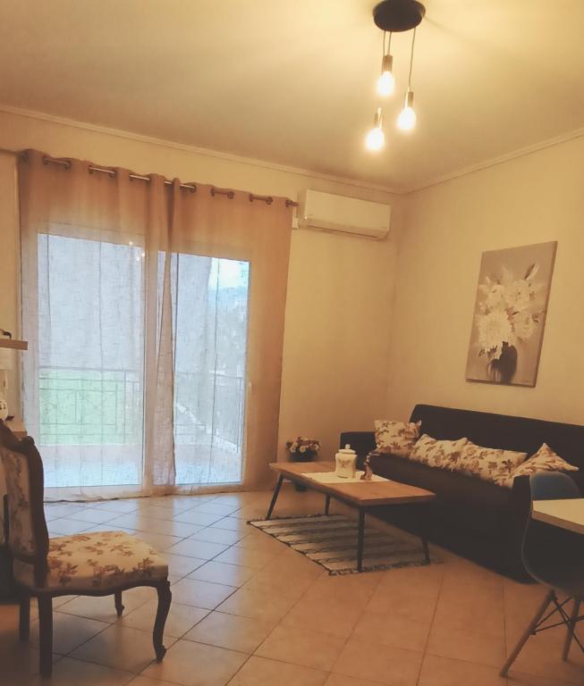 a living room with a couch and a table at Rosemary apartment in Eretria