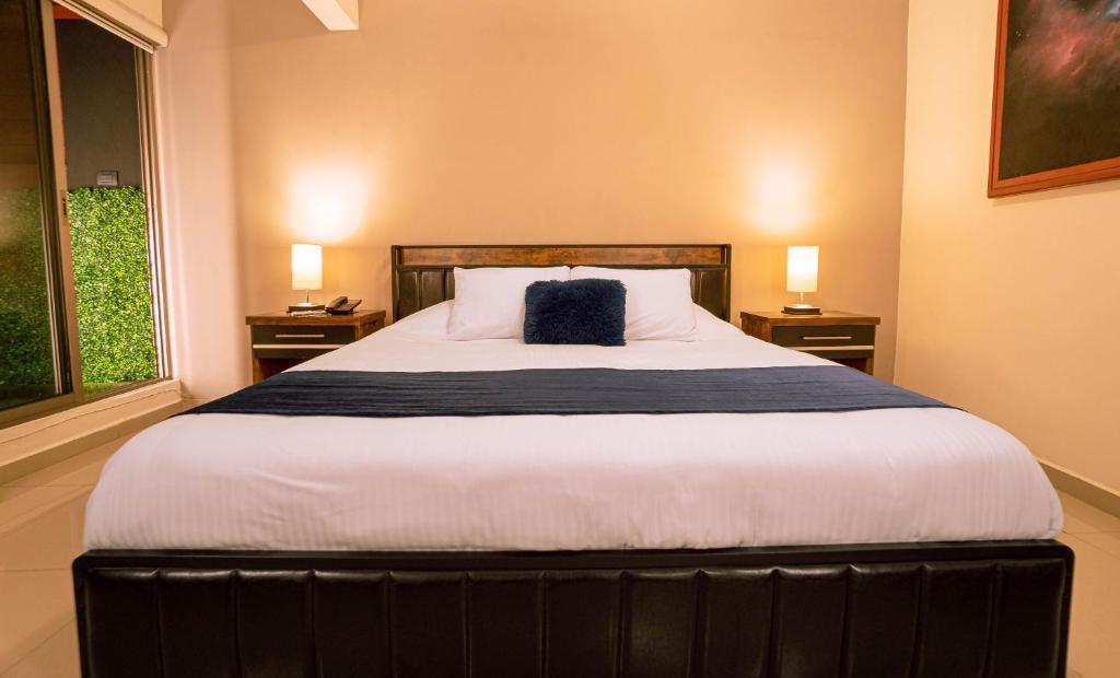 Postel nebo postele na pokoji v ubytování Hotel Quirasco