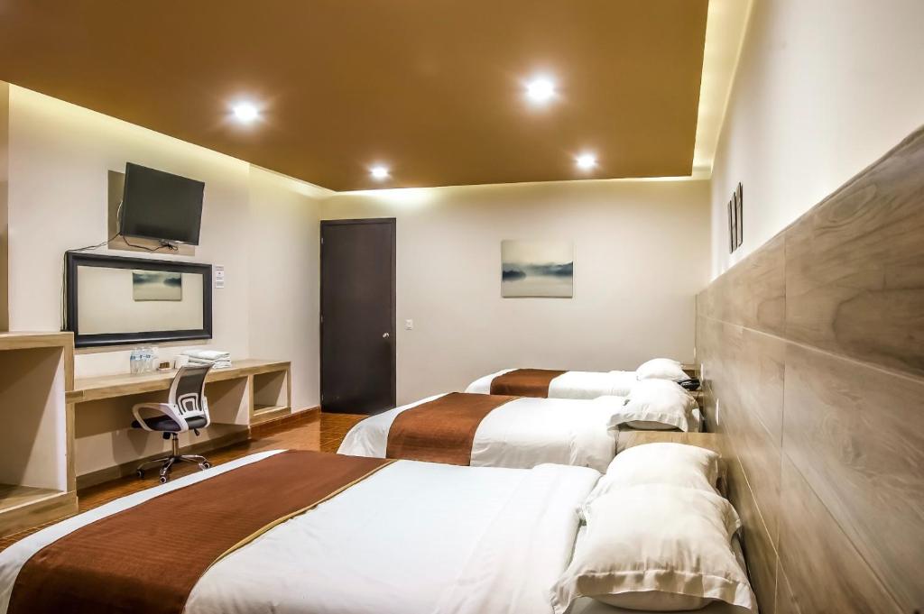 Postel nebo postele na pokoji v ubytování Hotel Luna Caribe