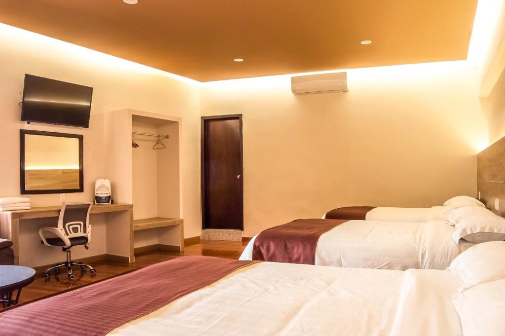 Postel nebo postele na pokoji v ubytování Hotel Luna Caribe