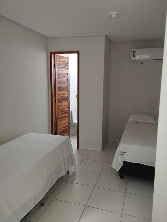 Postel nebo postele na pokoji v ubytování Hotel Algaroba Anexo