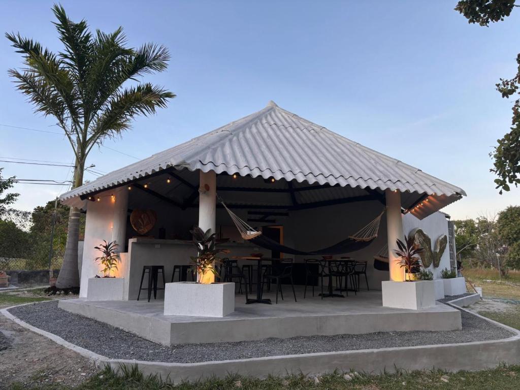 a house with a table and chairs in front of it at Kooteja Aurora Coronado Nature Villa with Private Pool & Glamping Experience in Las Lajas