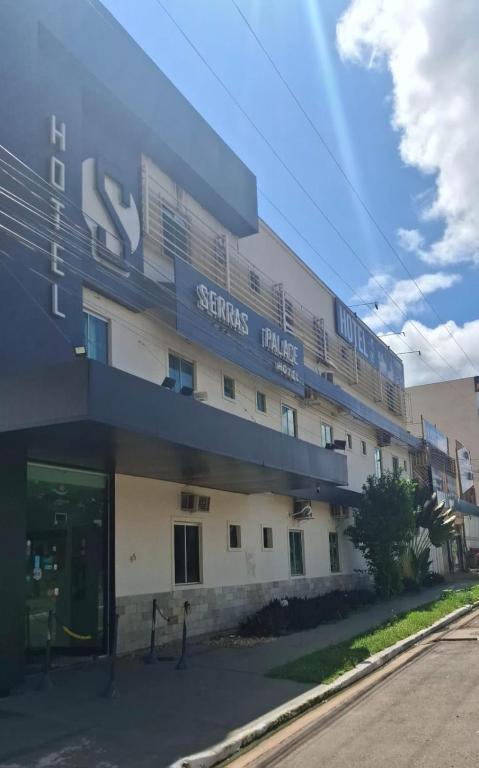 a building with a sign on the side of it at Serra's Palace Hotel in Parauapebas