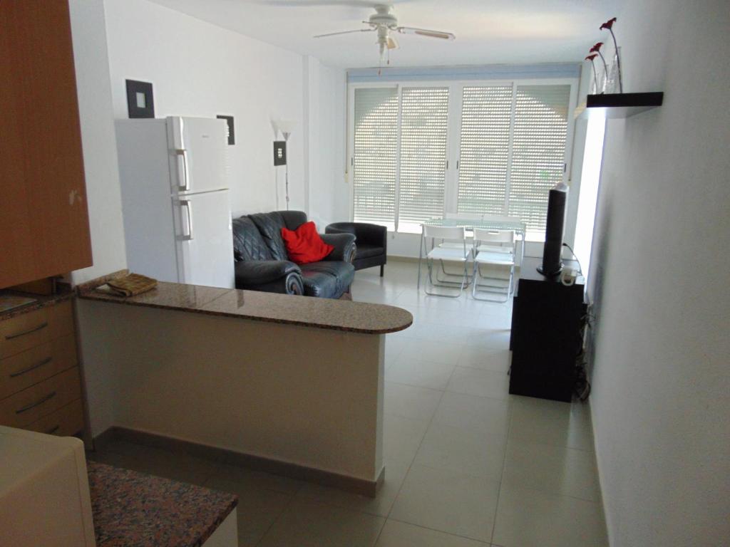 a kitchen and living room with a couch and a refrigerator at Puertosol in Puerto de Mazarrón