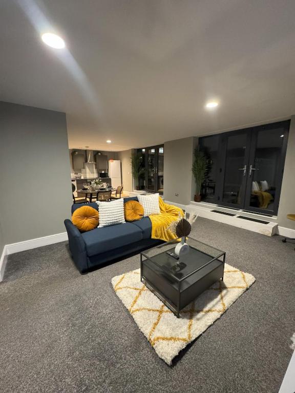 a living room with a couch and a table at Ancoats 2BR with Private terrace in Manchester