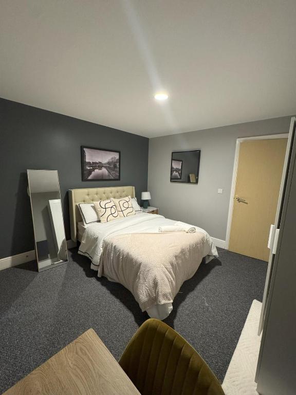 a bedroom with a large bed in a room at Ancoats 2BR with Private terrace in Manchester