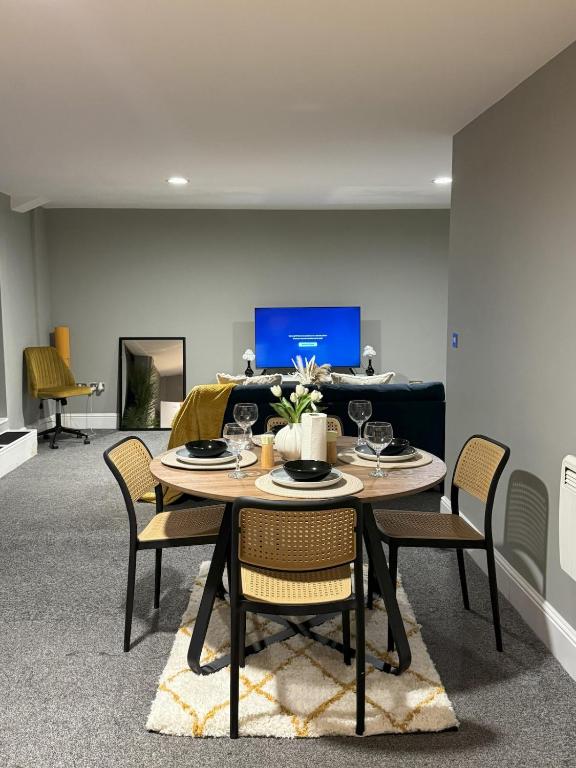 a dining room with a table and chairs at Ancoats 2BR with Private terrace in Manchester