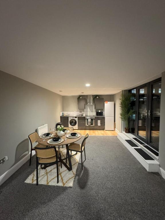a kitchen and dining room with a table and chairs at Ancoats 2BR with Private terrace in Manchester