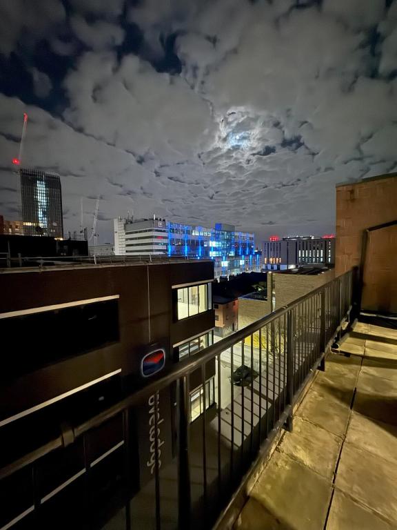 a view of a city skyline at night at Ancoats 2BR with Private terrace in Manchester
