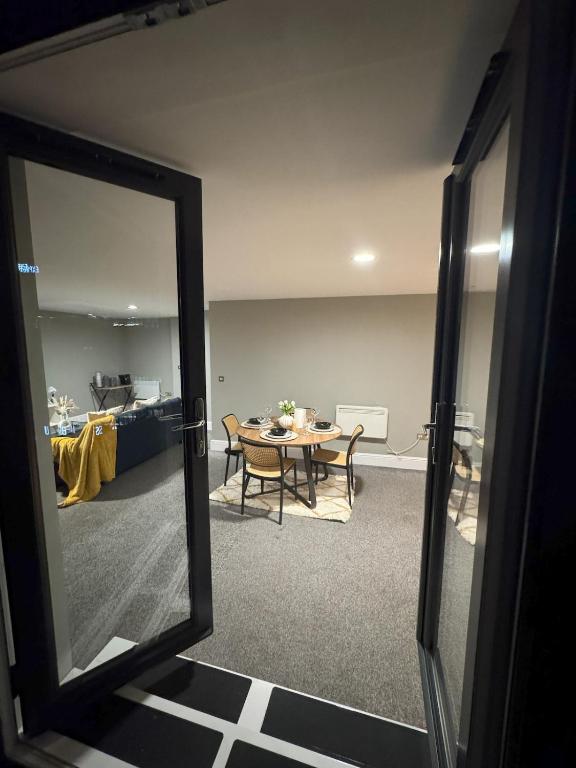 a mirror in a room with a table and a dining room at Ancoats 2BR with Private terrace in Manchester