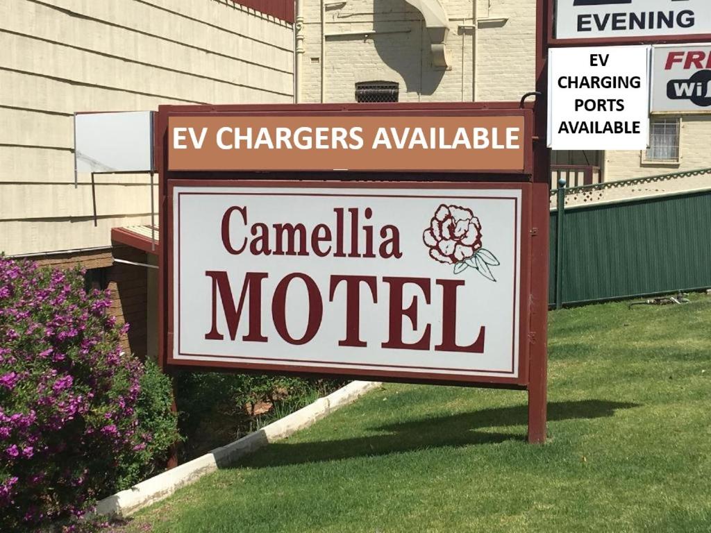 a sign for camelia motel in front of a house at Camellia Motel in Narrandera