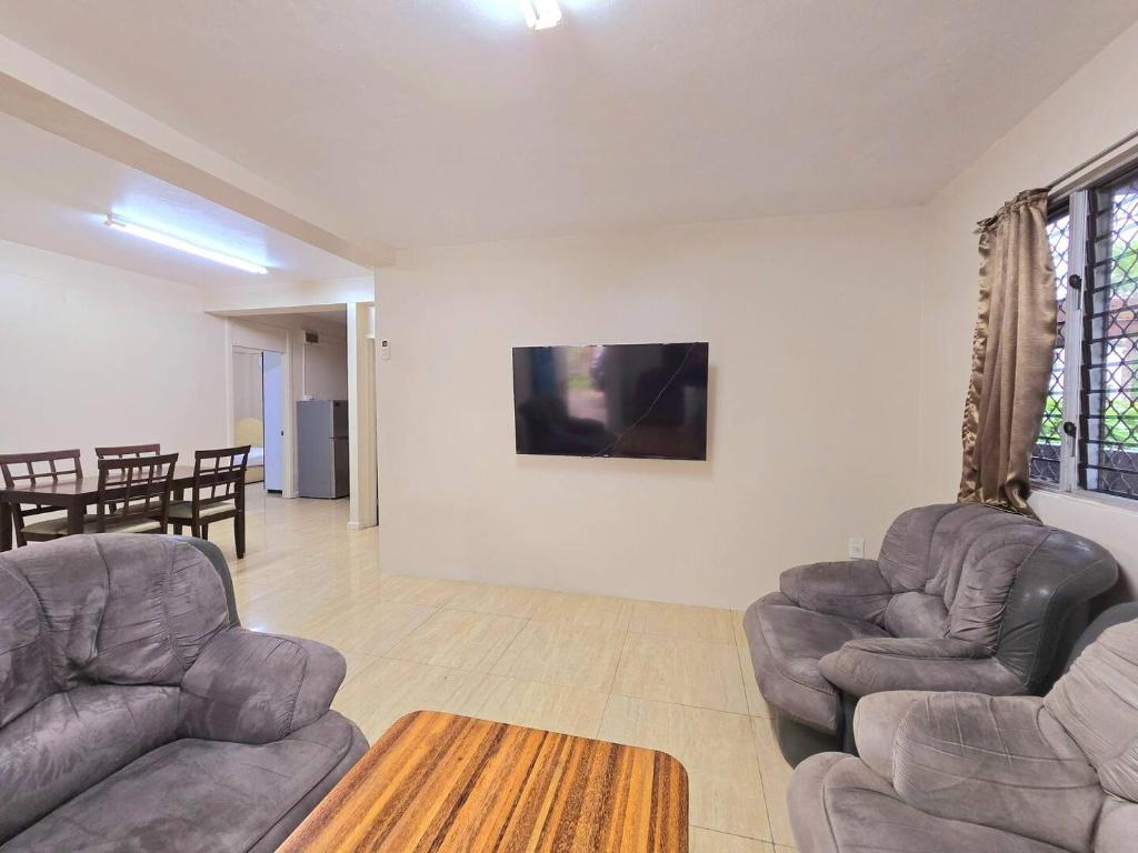 a living room with two chairs and a table at Private Entire Family Stay in Suva in Suva