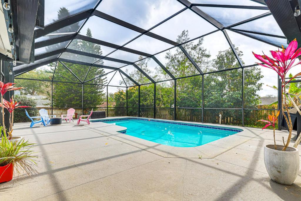 a swimming pool in a glass house with a swimming pool at Swim, Golf and Relax Lovely Home in Lake Mary in Lake Mary