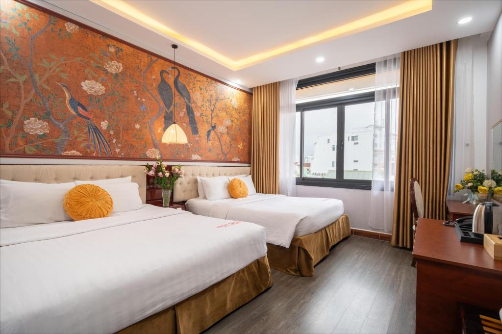 Giường trong phòng chung tại Thuy Duong Boutique Hotel Hue