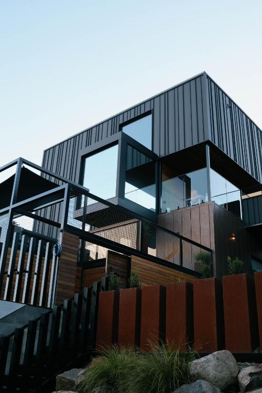 a modern house with a staircase andwindows at Luxe Hobart Villa - Boxwood in Hobart